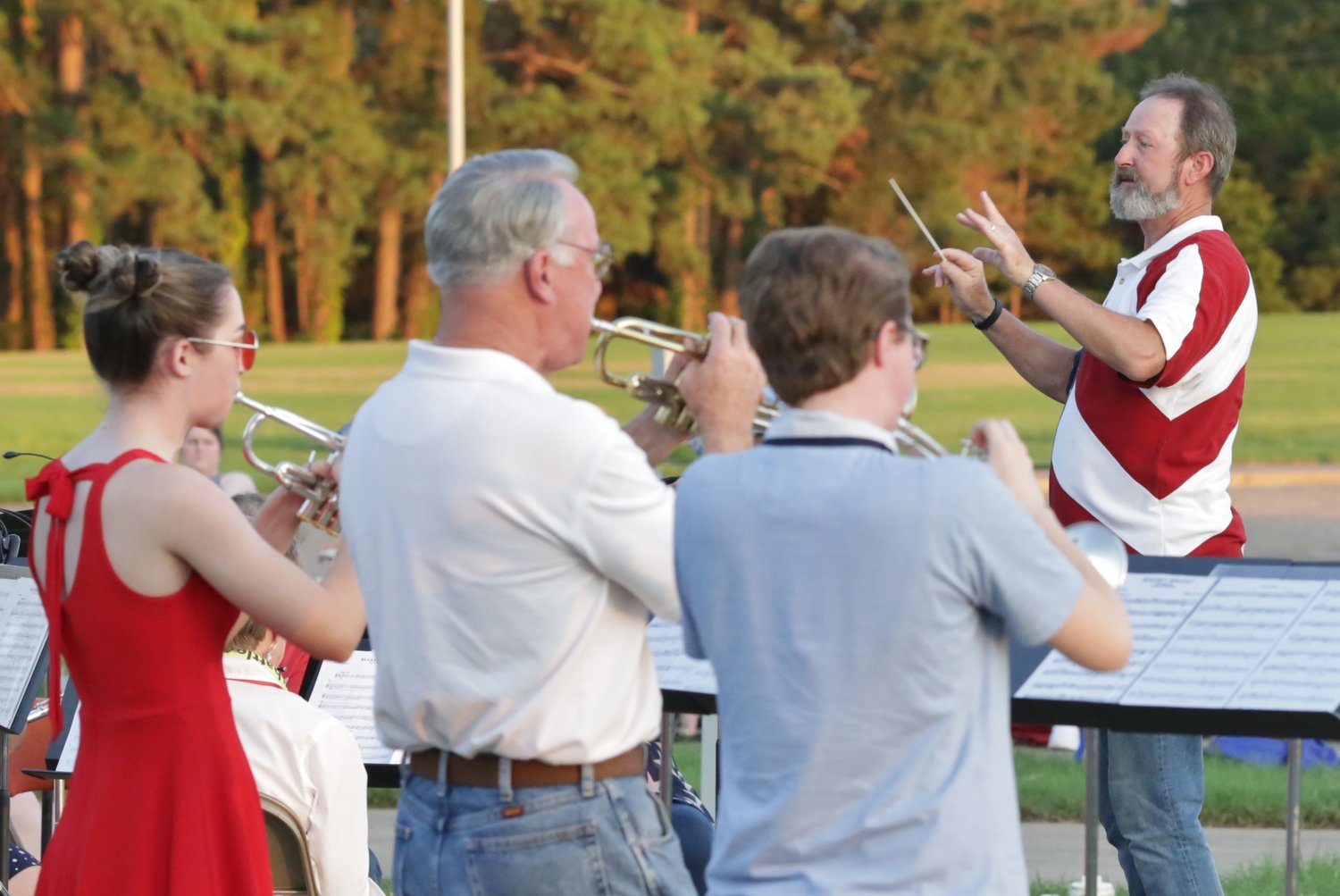 Lake Country Symphonic Band conductor Mike Holbrook and the trumpet section lead the band at Sunday’s Independence Day celebration at the Mineola Civic Center.